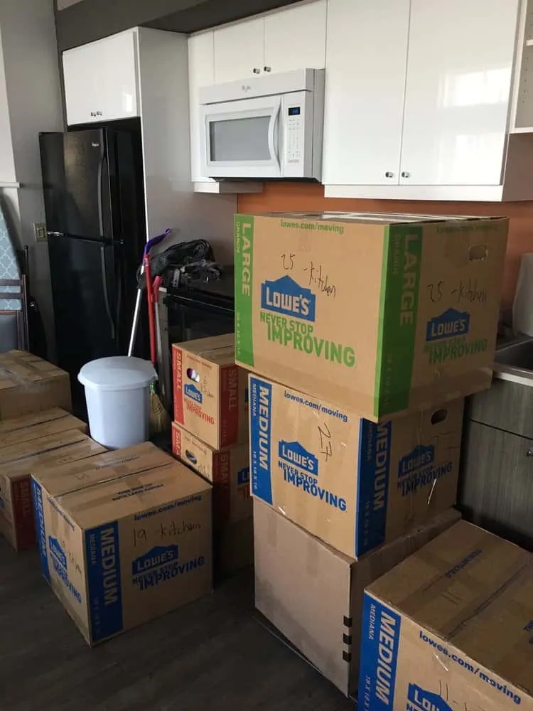 Stacked moving boxes in a kitchen